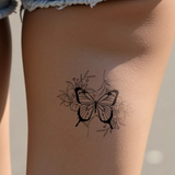 butterfly surrounded by flowers tattoo