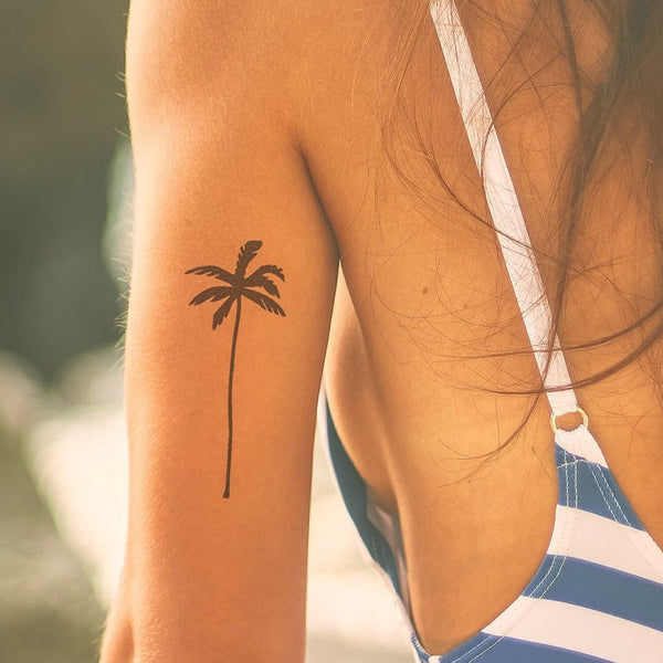 Black palm tree tattoo on the ankle - Tattoogrid.net
